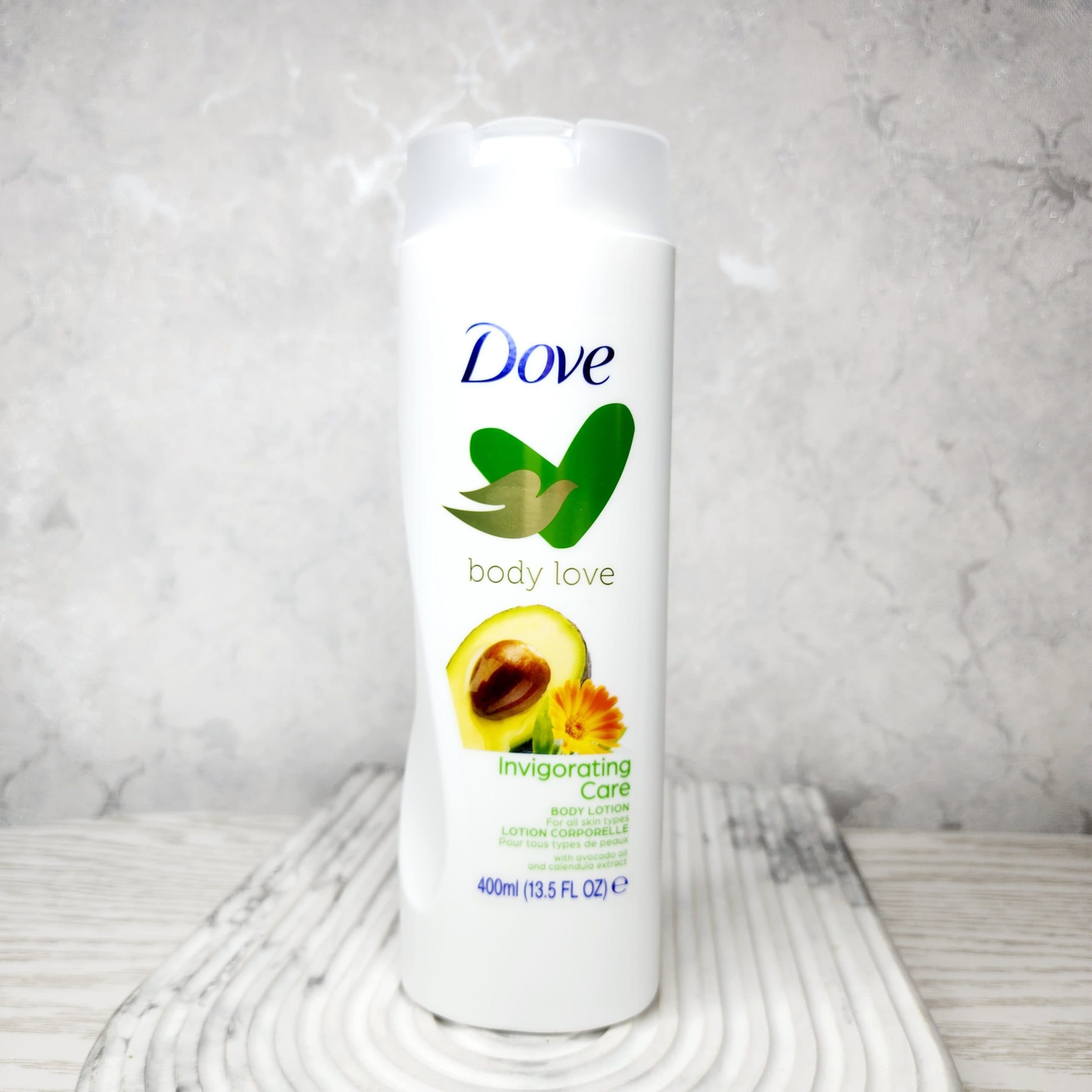 لوسیون بدن داو Dove مدل Invigorating Care حاوی روغن آووکادو و عصاره گل کالاندولا حجم 400 میل