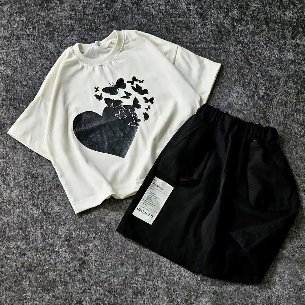 ست کراپ شلوارک دخترانه مدل قلب پروانه ای کرم مشکی سایز 5,50,55,60 — تصویر ۱۲