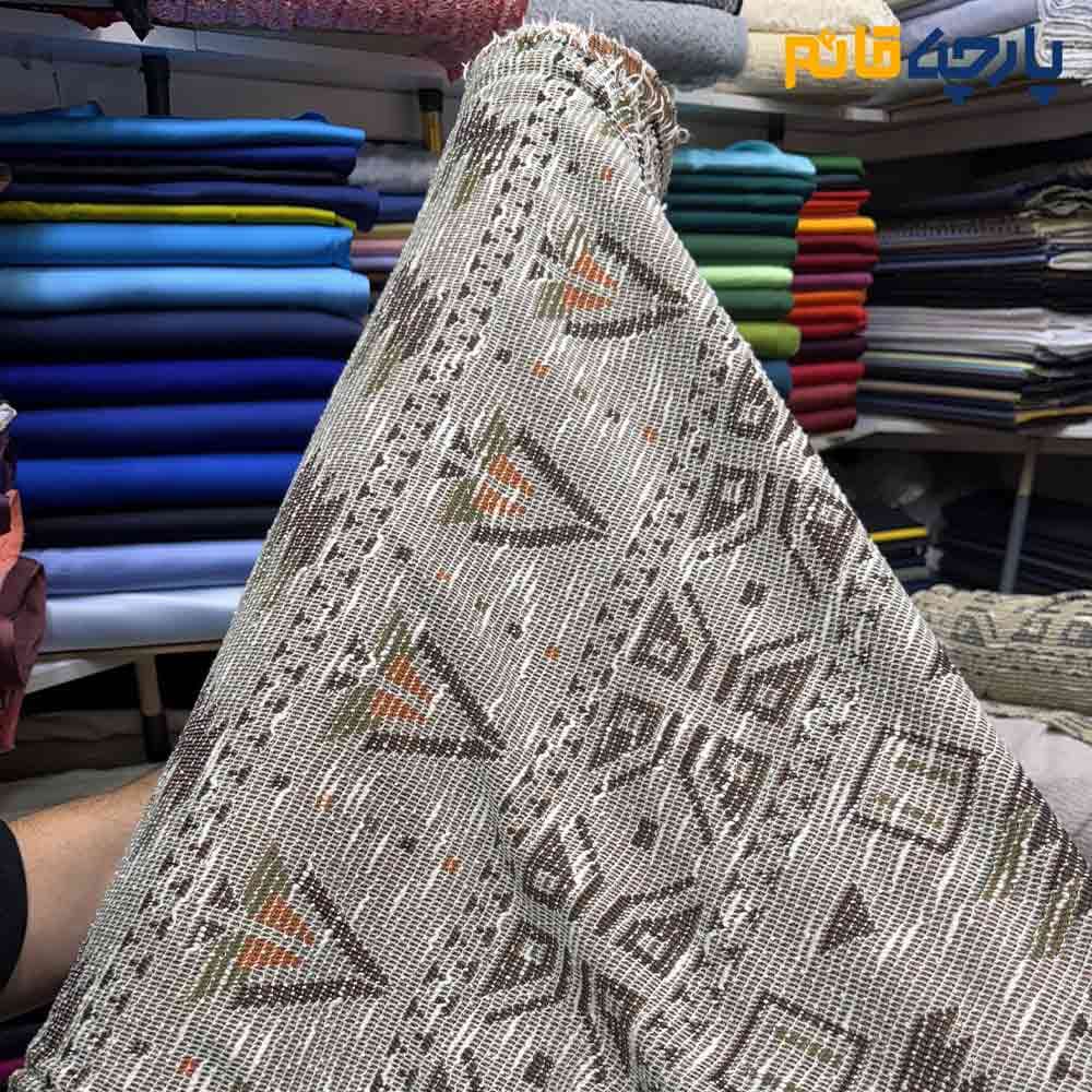 پارچه پاییزه و زمستانه بافت تریکو طرح موناکو رنگ کرم طلایی با نارنجی عرض150 کد 13568