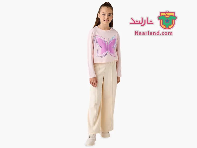 تیشرت کراپ آستین بلند نخی برند Juniors صورتی پولک دار طرح پروانه — تصویر ۳