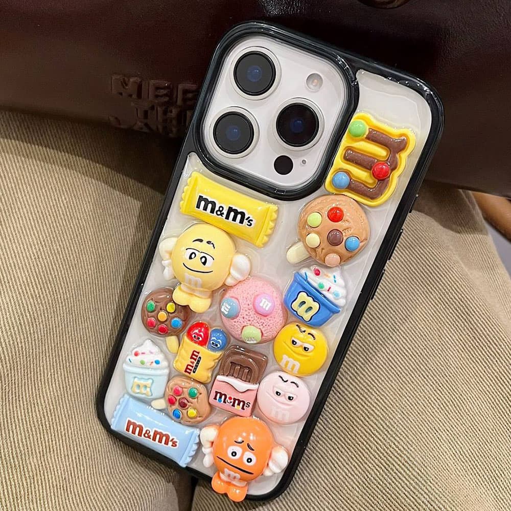 قاب M&M برجسته همراه با آویز کد CST مناسب برای گوشی موبایل آیفون Apple iPhone 7Plus / 8Plus / X / XS / XS Max / 11 / 11 Pro / 11 Pro Max / 12 / 12 Pro / 12 Pro Max / 13 / 13 Pro Max / 14 / 14 Pro