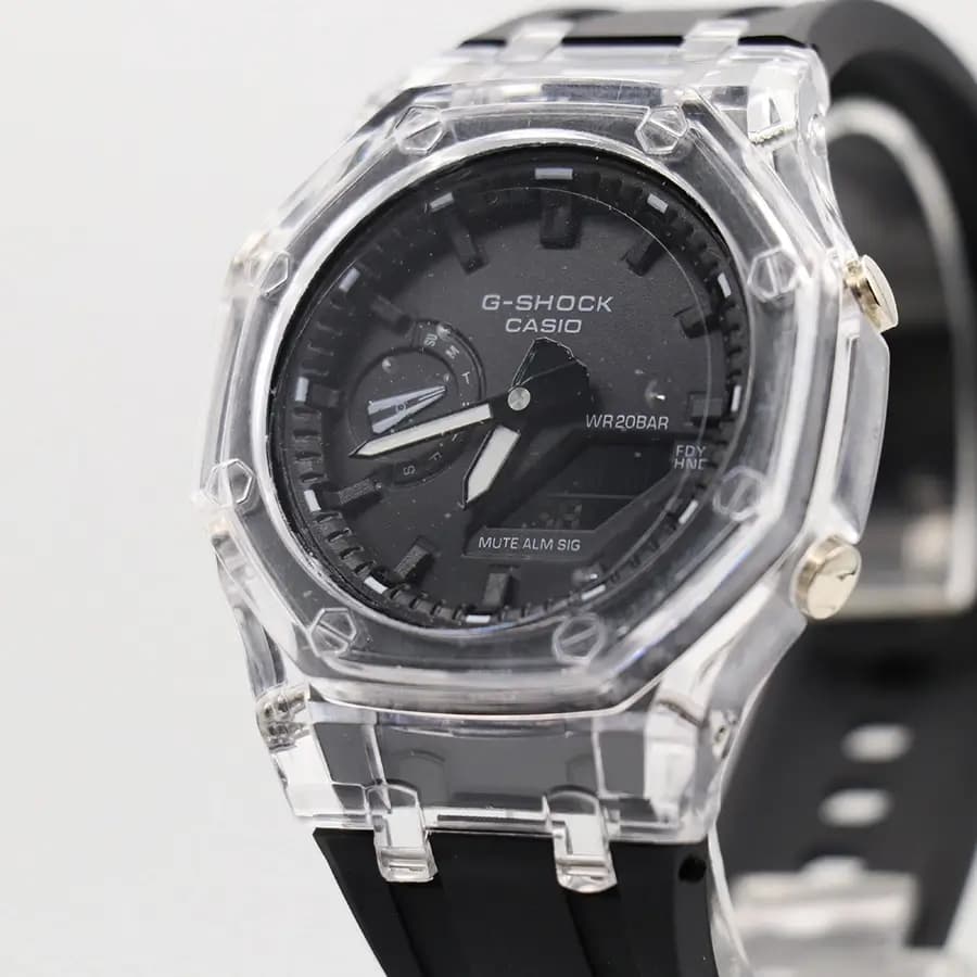 ساعت مردانه CASIO G-SHOCK قاب شفاف، صفحه مشکی آنالوگ و دیجیتال، بند سیلیکونی مشکی، قاب هشت‌ضلعی، نمایش تاریخ و روزهای هفته، موتور کوارتز دوزمانه، قفل سگکی پین‌دار مدل GA-2100 — تصویر ۴