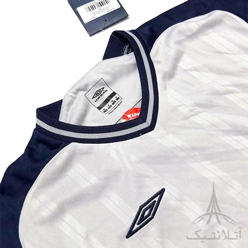 بلوز آستین دار ورزشی پسرانه فوتبالی برند آمبرو Umbro اورجینال وارداتی طوسی سرمه ای — تصویر ۴