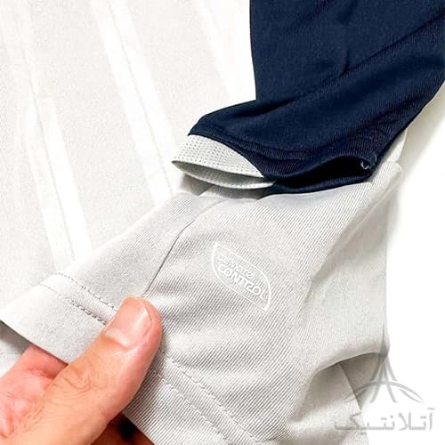 بلوز آستین دار ورزشی پسرانه فوتبالی برند آمبرو Umbro اورجینال وارداتی طوسی سرمه ای — تصویر ۵