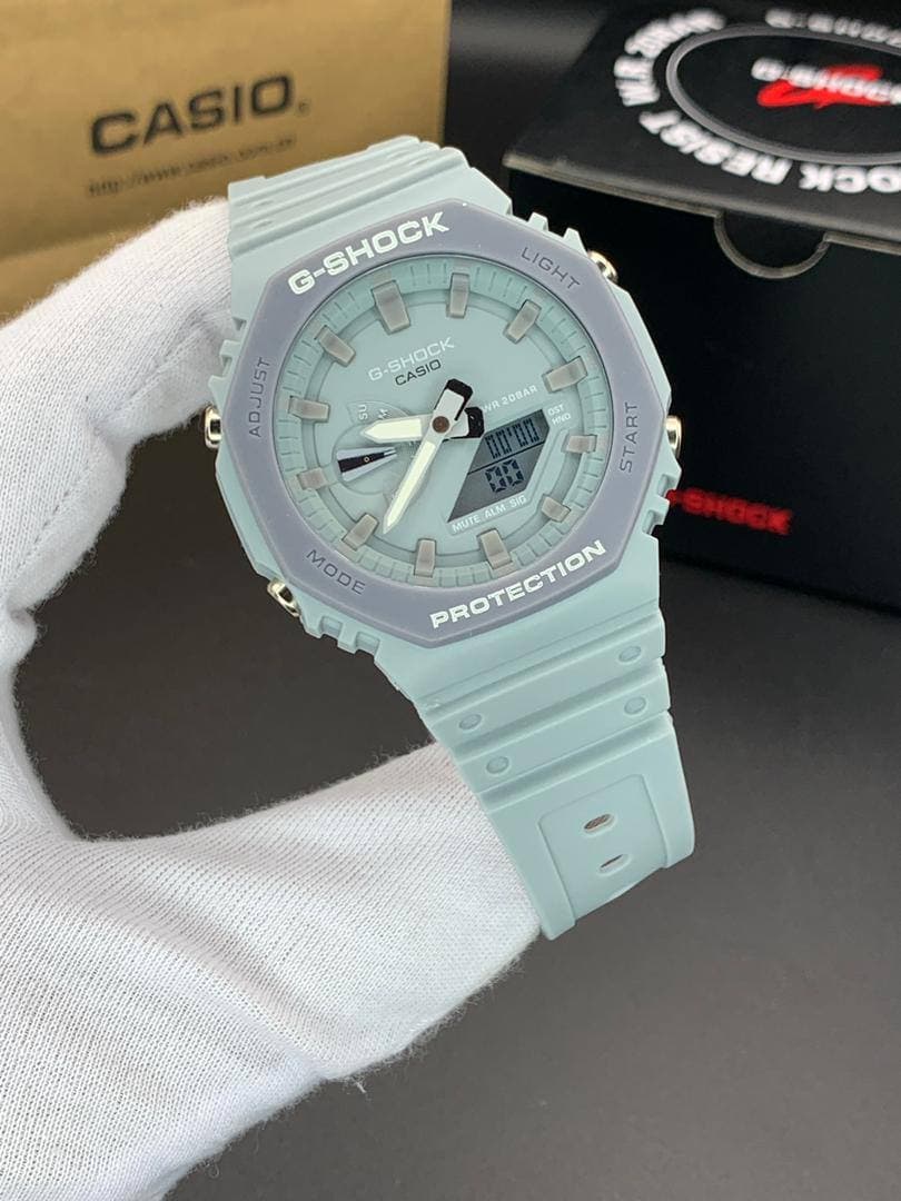 ساعت مچی کاسیو جیشاک مدل GA-2100 صفحه آبی روشن دور طوسی بند آبی