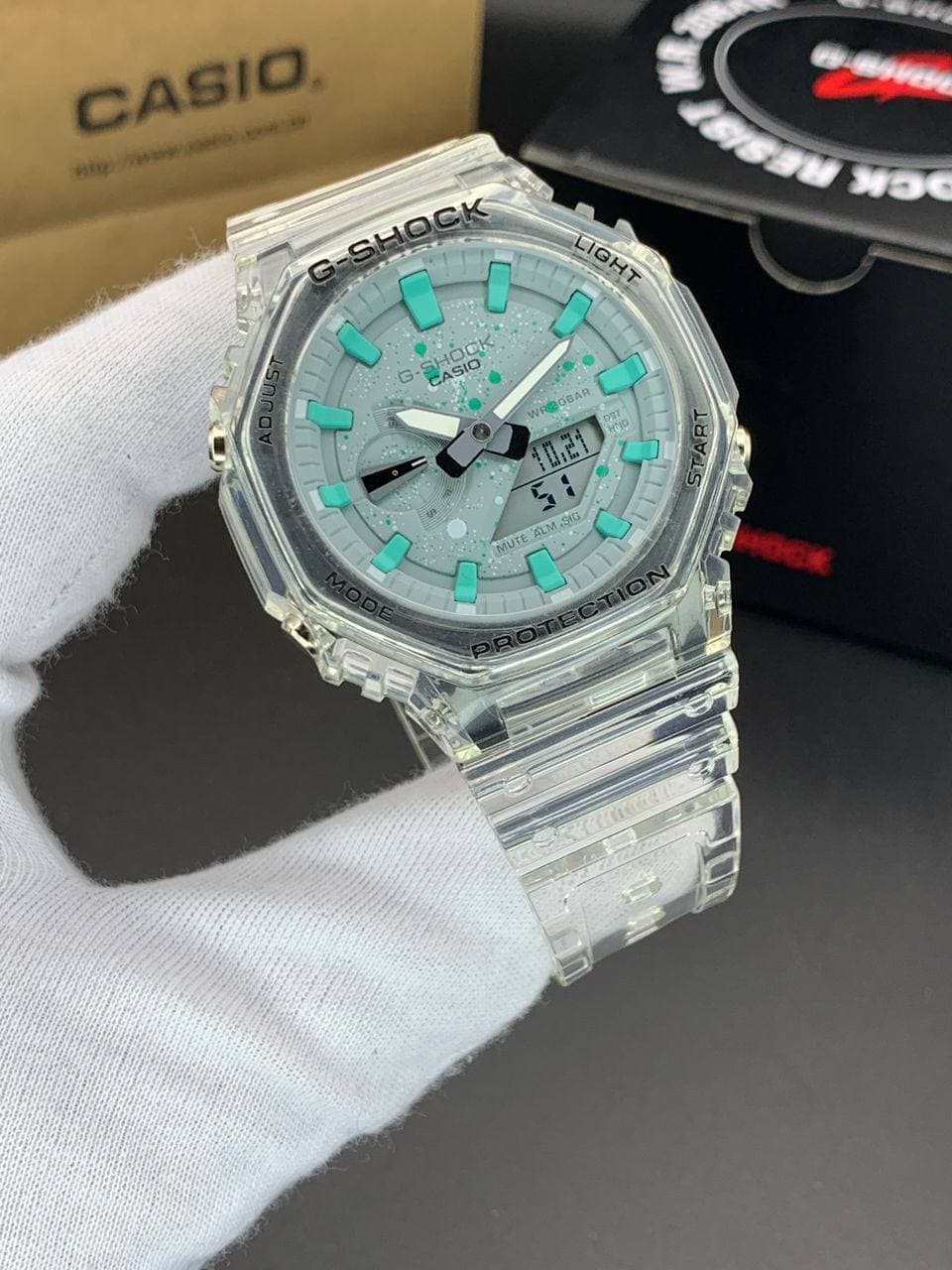 ساعت مچی کاسیو جیشاک مدل GA-2100 صفحه شفاف فیروزه ای بند شفاف