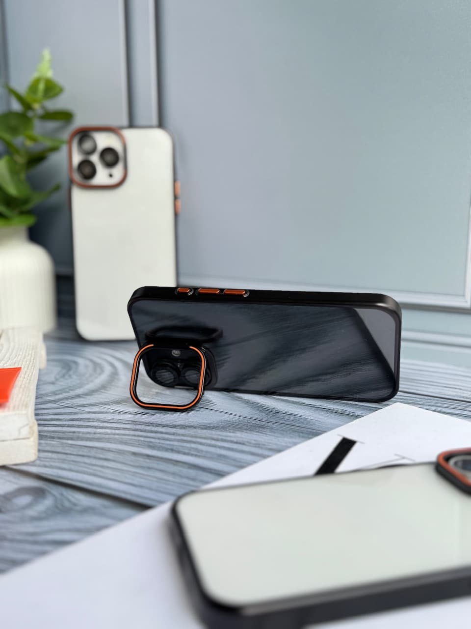 قاب orange lens استند شو با محافظ لنز (آیفون) — تصویر ۴