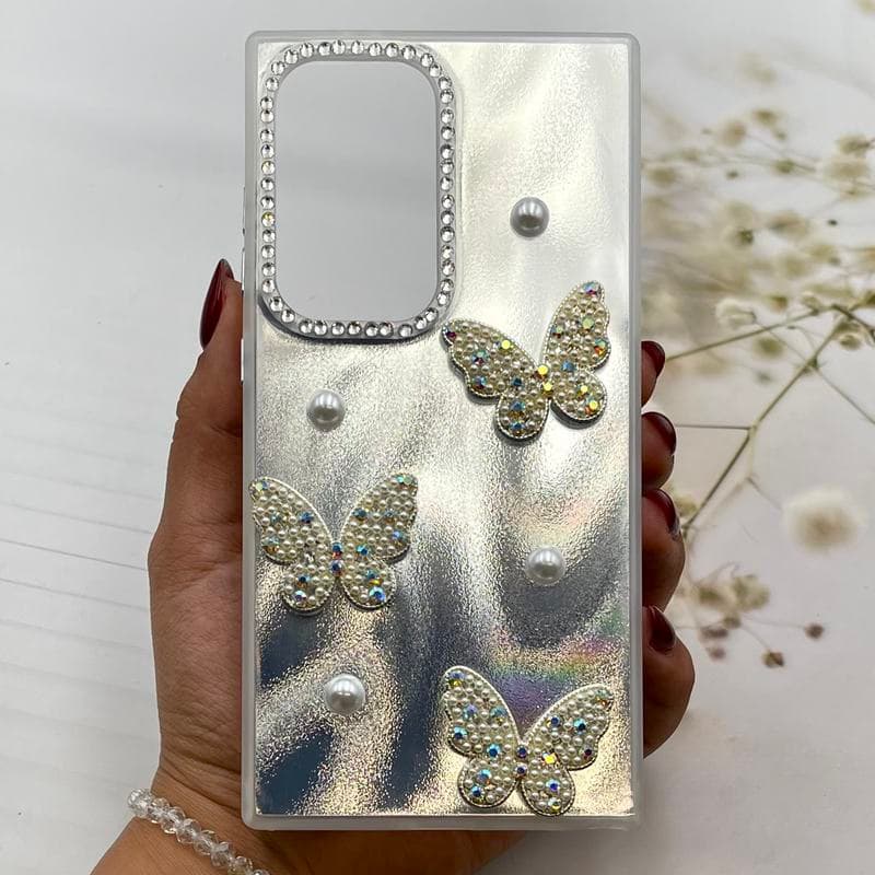 قاب گوشی Galaxy S24 Ultra سامسونگ براش مرواریدی طرح پروانه برجسته لنز نگینی نقره ای کد 155342
