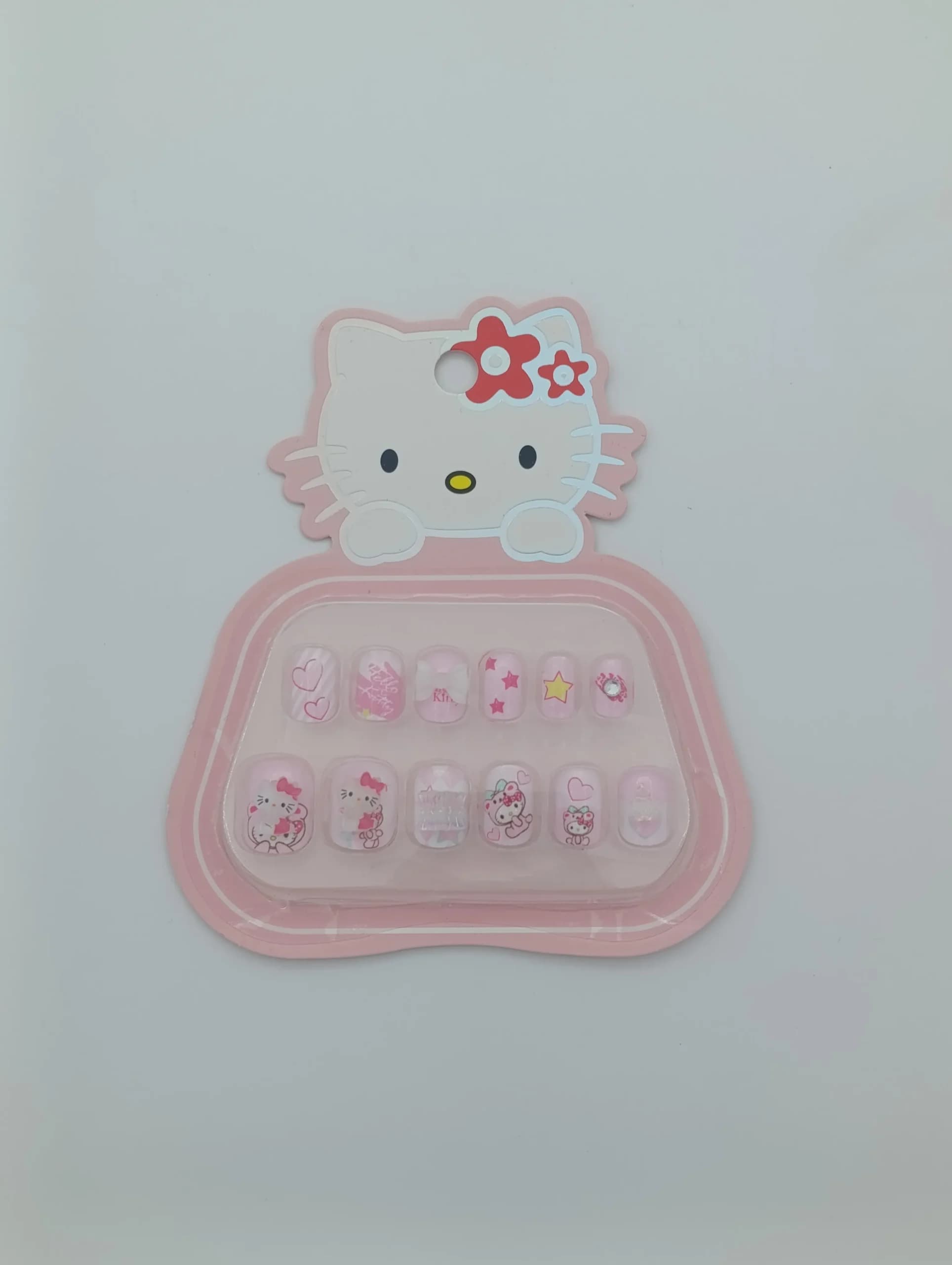 ناخن مصنوعی بچگانه طرح هلو کیتی Sanrio Hello Kitty بسته ۱۲ عددی | دارای چسب ژلهای ایمن، پاپیون ۳ بعدی برجسته و نگین کریستالی